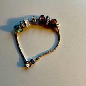 Silver tone miracle bracelet with 7 stone charms.